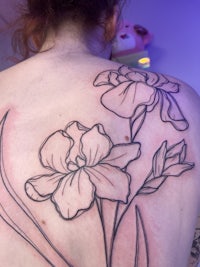 a woman with a tattoo of flowers on her back