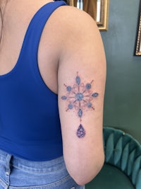 a woman with a snowflake tattoo on her arm