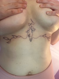 a woman with a tattoo on her chest