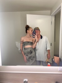 a man and woman taking a selfie in a bathroom