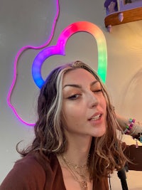 a woman wearing a rainbow heart shaped headband