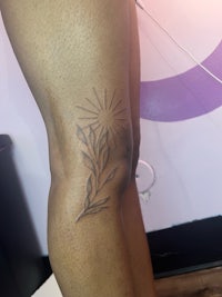 a woman with a tattoo on her thigh